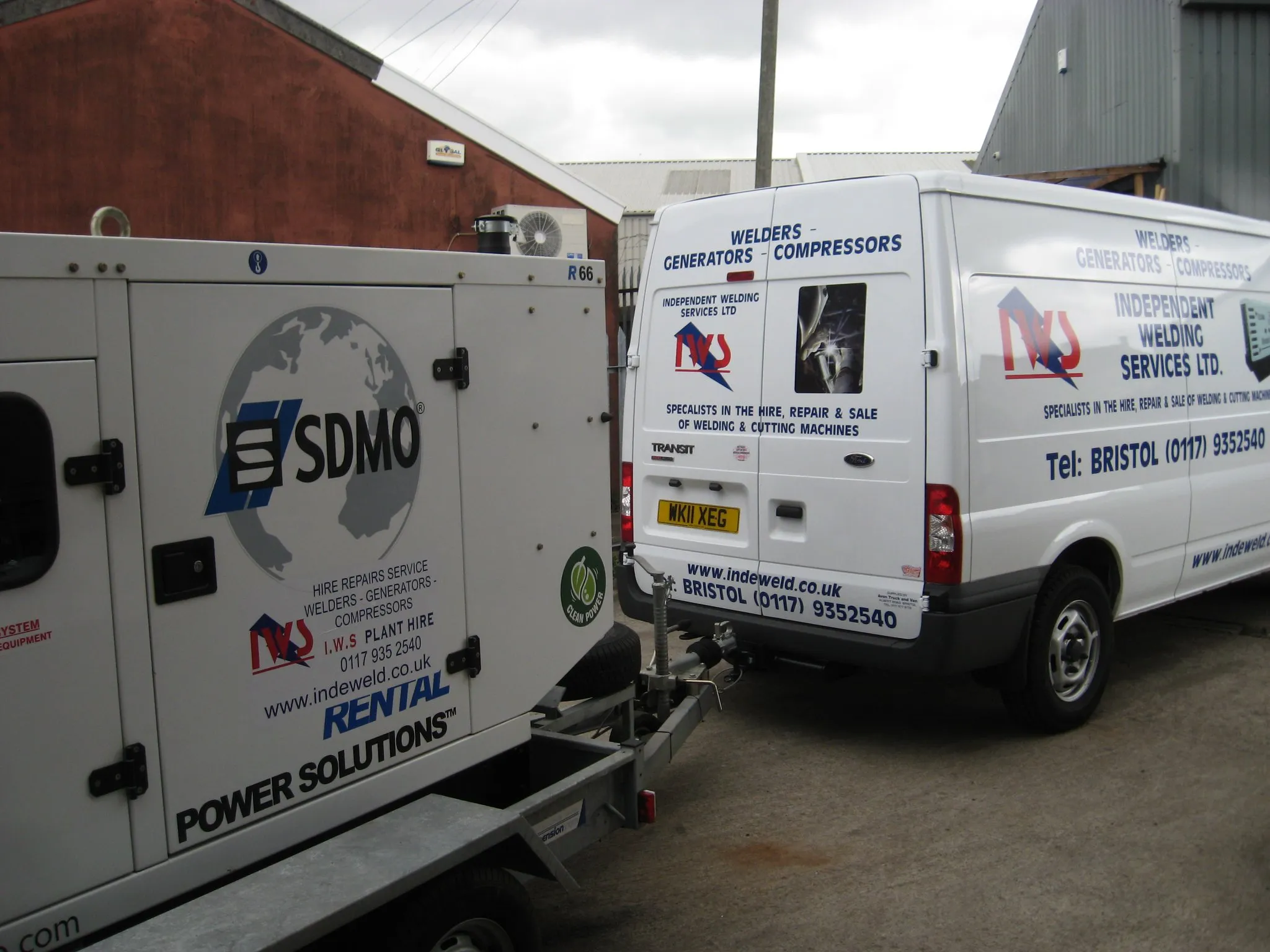 A white van parked in front of a building.