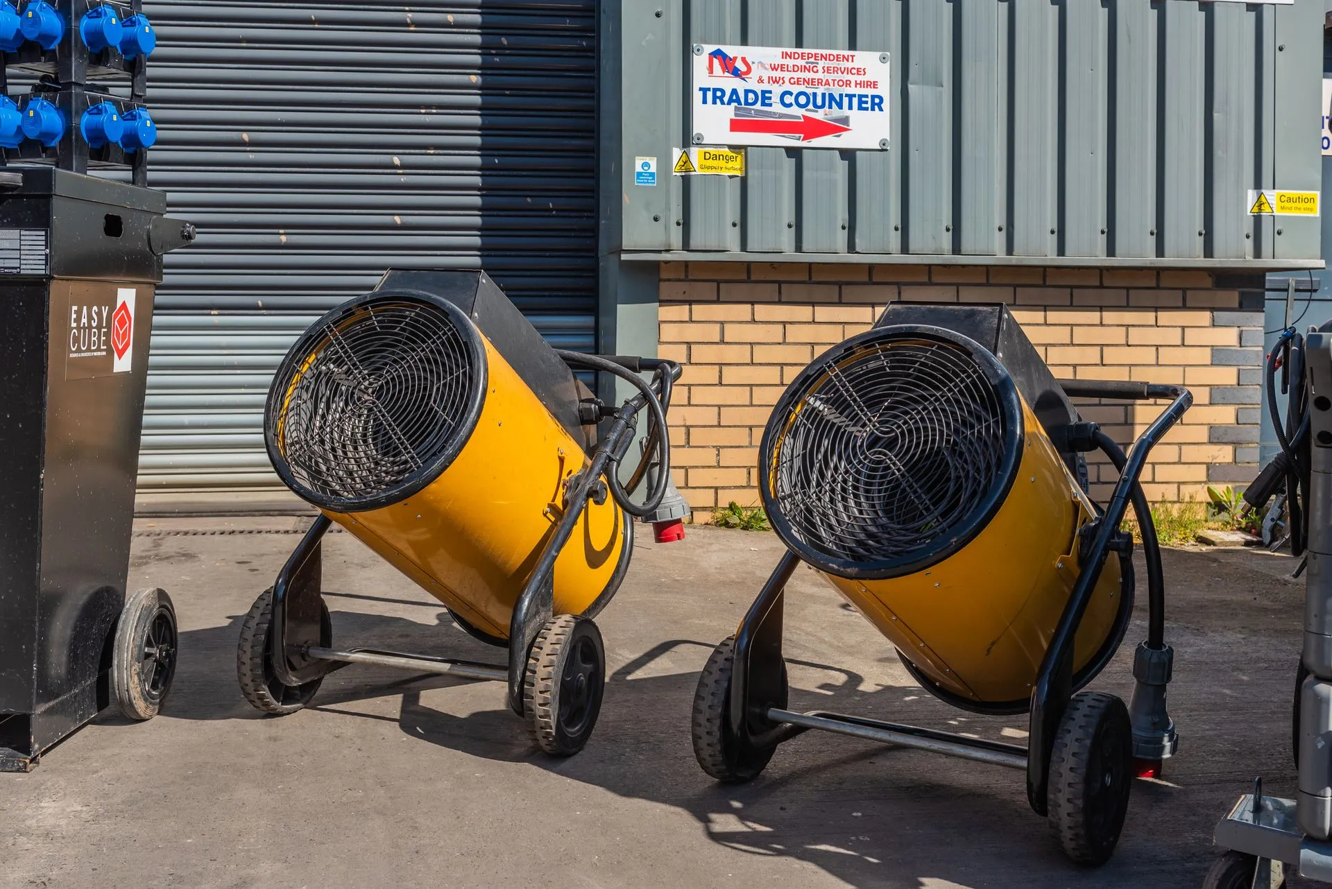 A couple of yellow air movers sitting next to each other.