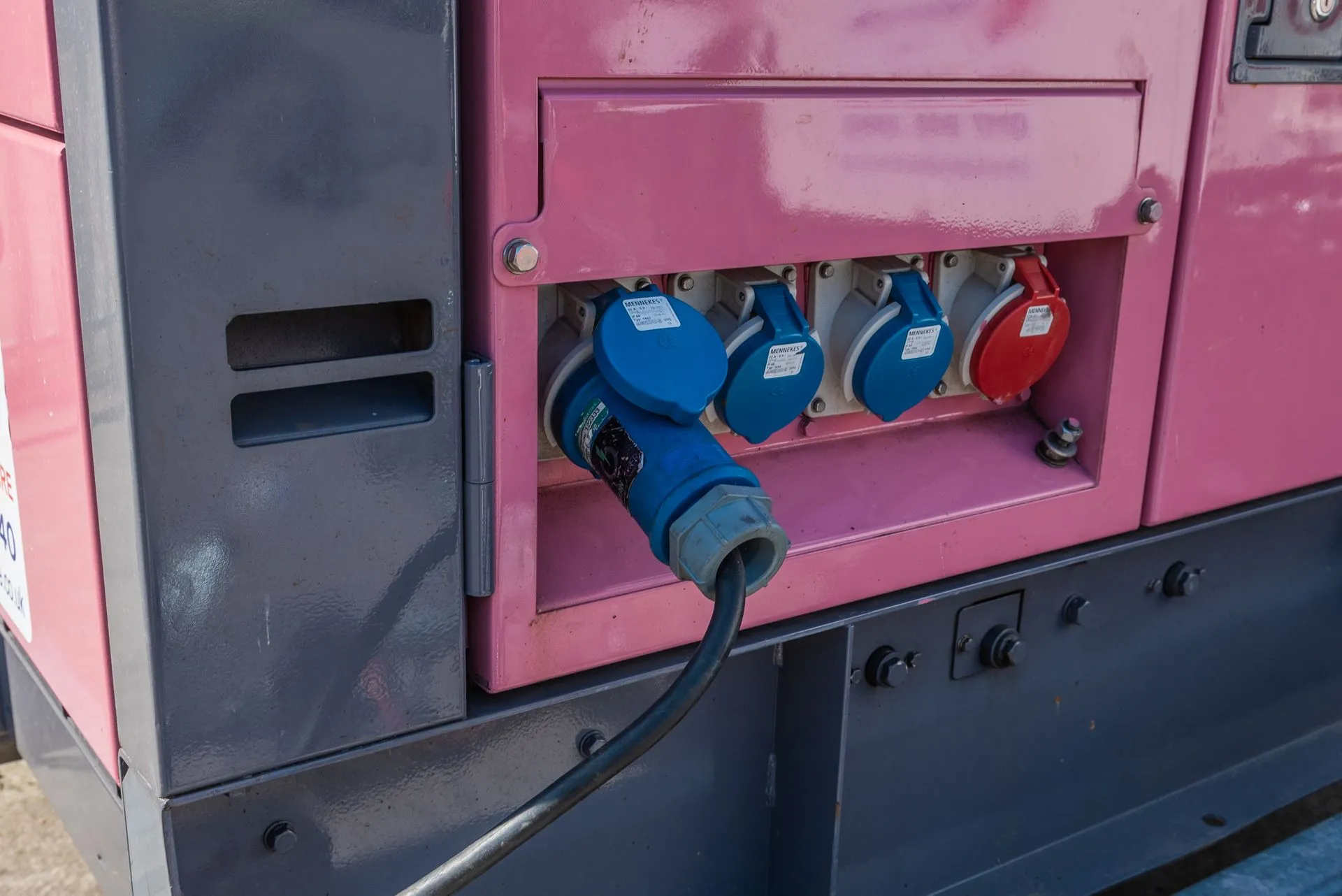A close up of a pink and blue machine.