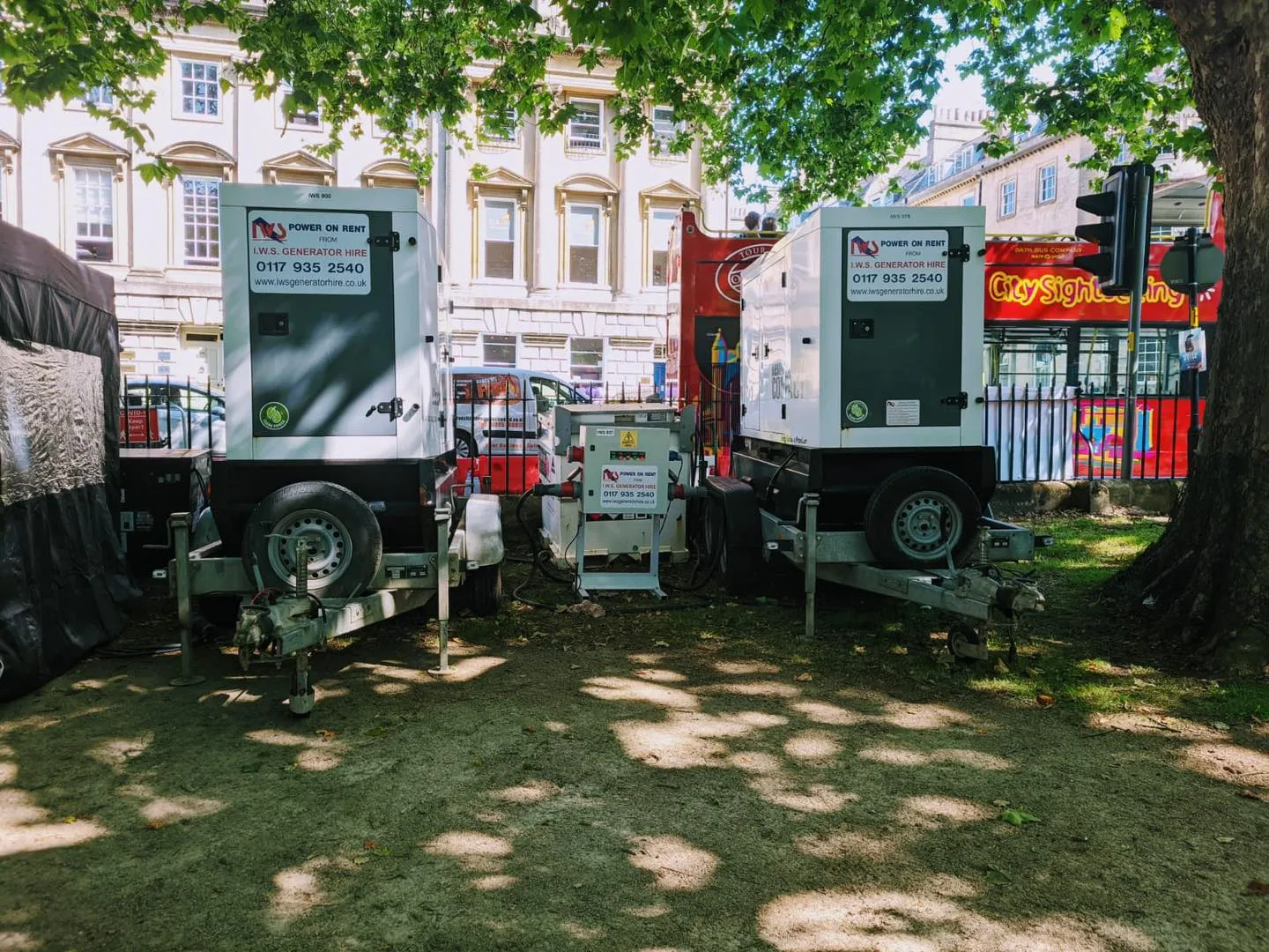 A couple of trucks parked next to each other on a field.