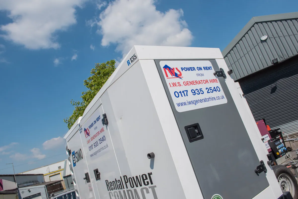 A group of portable generators sitting in front of a building.